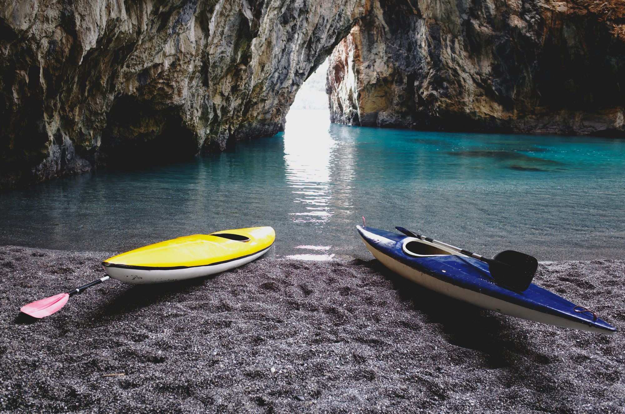 Two kayaks resting at a serene cove